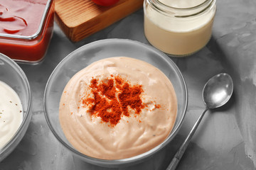 Bowl with tasty fish taco sauce on kitchen table