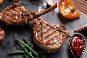 Delicious ribs and vegetables on slate plate