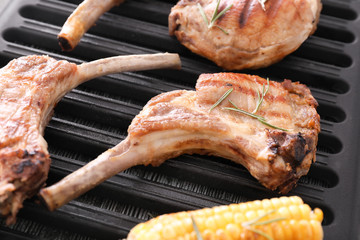 Delicious ribs on grill rack, closeup