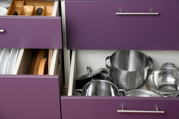 Different kitchenware in drawers