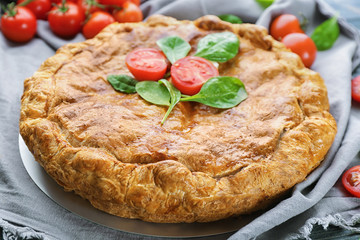 Tasty pie with spinach on table