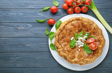 Tasty pie with spinach on table