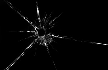 bullet hole in glass close up on black background - obrazy, fototapety, plakaty