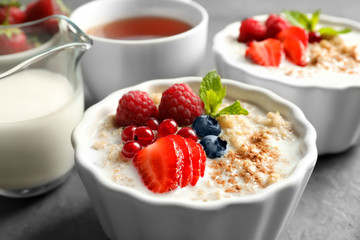 Tasty quinoa with berries in bowl on table