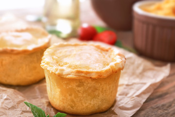 Delicious meat mini pies on parchment, closeup