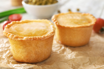 Delicious meat mini pies on parchment, closeup