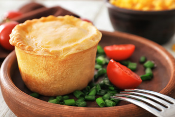 Delicious meat mini pie in wooden bowl, closeup
