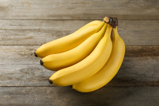 Yummy bananas on wooden background