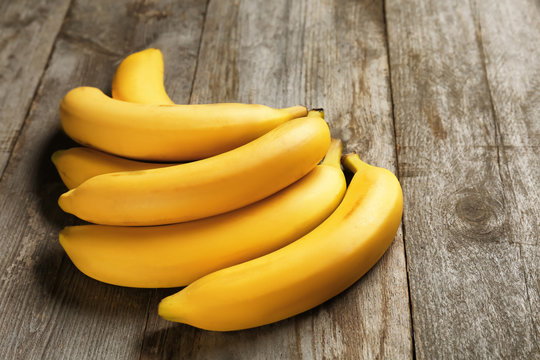 Yummy bananas on wooden background