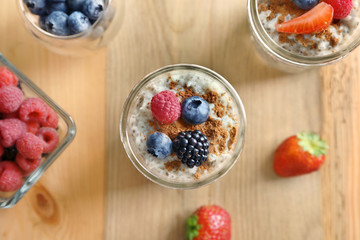 Jar of delicious chia seed pudding with berries on table