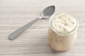 Jar with delicious chia seed pudding on table