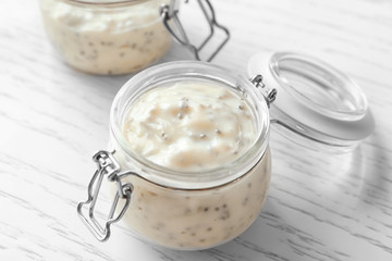 Jar with delicious chia seed pudding on table