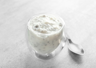 Glass with delicious chia seed pudding on table