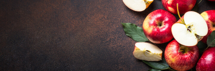 Red apples with leaves on the table. Long banner format.