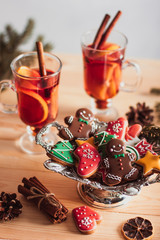 Beautiful Christmas background with mulled wine in a glass, gingerbread and New Year decor