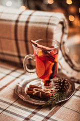 Beautiful Christmas background with mulled wine in a glass, gingerbread and New Year decor