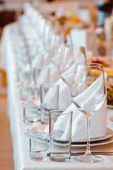 Served table with glasses and plates in the restaurant