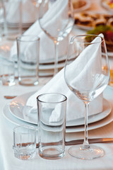 Served table with glasses and plates in the restaurant