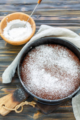 Chocolate cake sprinkled with powdered sugar.