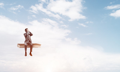 Young man on book in blue sky do not want to see anything