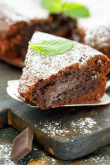 Piece of chocolate cake dusted with powdered sugar.