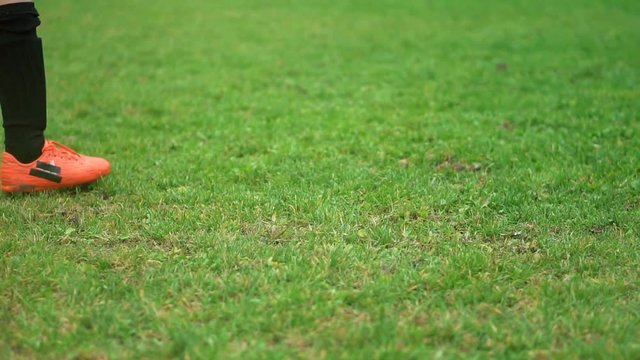 Close-up of young soccer player taking a penalty kick