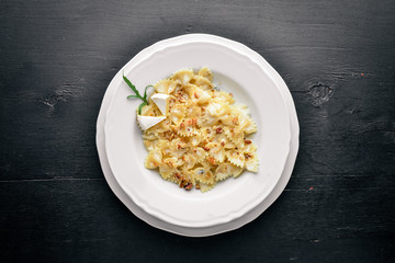 Pasta four cheeses. Italian food. On a wooden background. Top view. Free space for text.