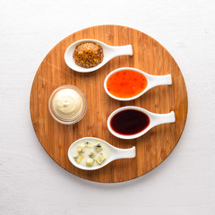 A set of sauces and spices. On a wooden background. Top view. Free space for text.