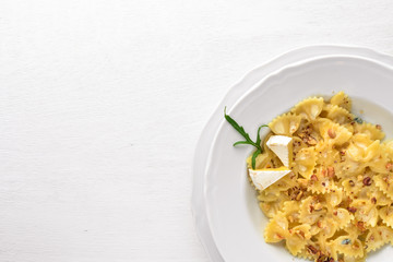 Pasta four cheeses. Italian food. On a wooden background. Top view. Free space for text.