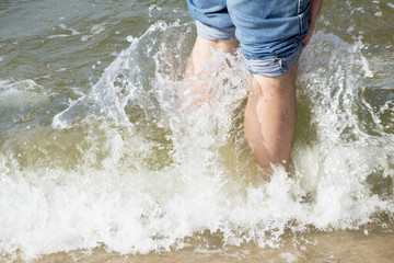 legs in wave sea photo. Beautiful picture, background, wallpaper