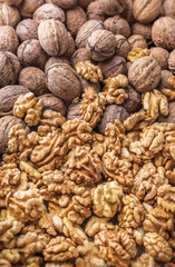 Overhead large group  of walnuts in golden kernel and peel background in studio