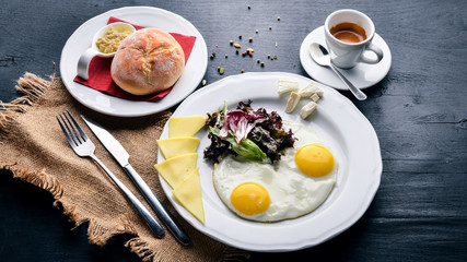 Breakfast. Egg and Burger Beef. Potato frying. On a wooden background. Top view. Free space for text.