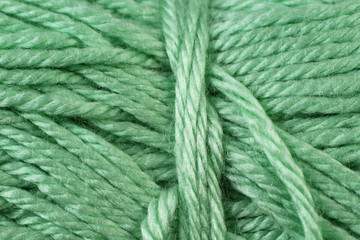 A super close up image of sage green yarn