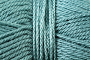 A super close up image of teal yarn