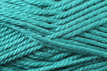 A super close up image of turquoise yarn