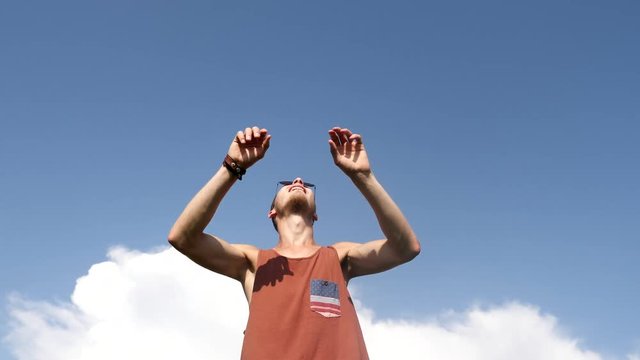 Man playing volley ball game under blue sky.