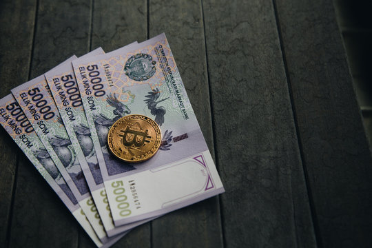 Uzbek banknotes and Bitcoin. Fifty Thousand Uzbek Sums