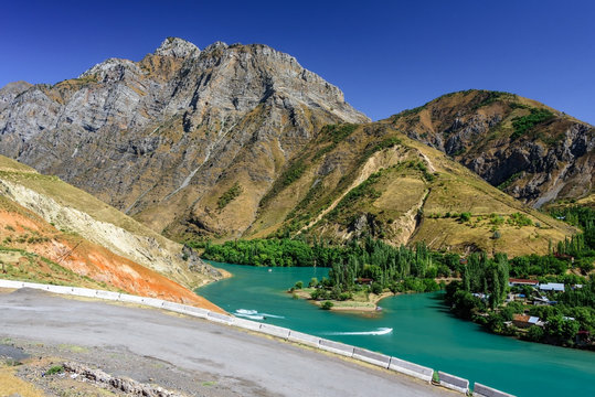 Panoramic view of Charvak Lake, a huge artificial lake-reservoir with azure water created by erecting a high stone dam on the Chirchiq River, located in Tashkent region of Uzbekistan