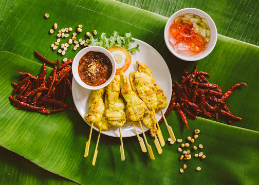 Chicken Satay with peanut hot sauce and chili pickle vinegar