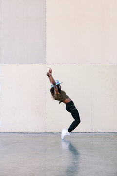 Young african american woman performing street dance in the city.