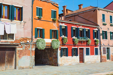 Fototapeta na wymiar Nice colorful houses street of Venice, Italy