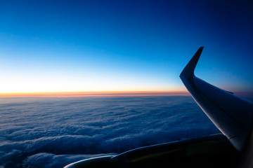 Sunset from the airplane, wing, clouds, sky.