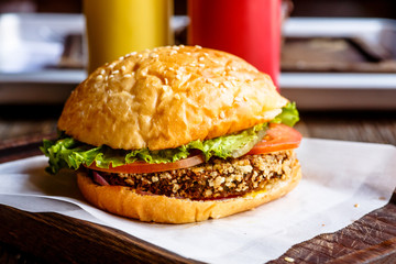 A regular Burger with a cutlet lies on paper