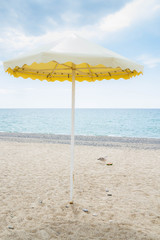 Yellow umbrella on the summer beach