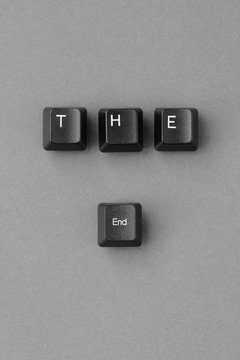 'The end' written with computer keyboard keys on a paper background