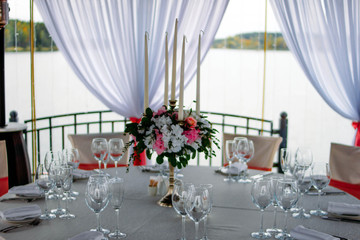wedding table decoration at the wedding, celebration in the gazebo on the lake