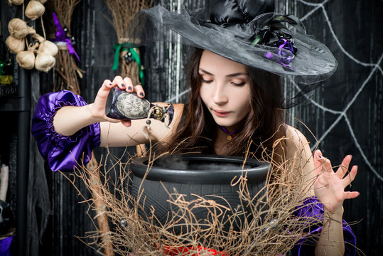 witch in a black hat in a pot cooks a potion