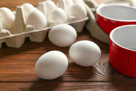 Carton package with hard boiled eggs on wooden table