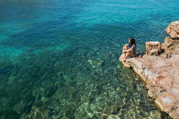 Woman in a beach with crystalline water