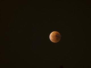 Blood Moon, Super Moon lunar eclipse, red moon eclipse with aircraft crossing